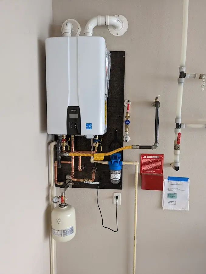 Professional plumber installing copper piping in a Waimea home